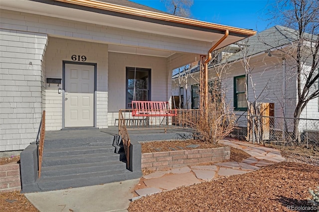 property entrance featuring a porch