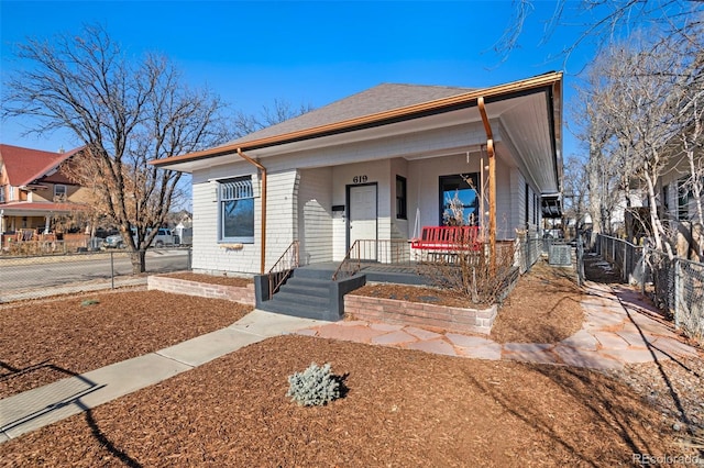 view of front of home with central AC unit and a porch