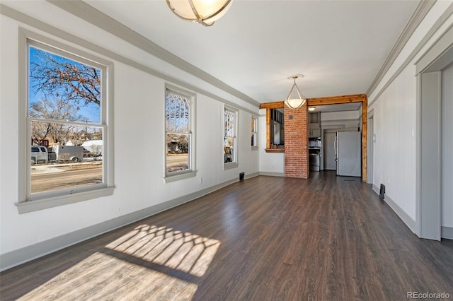 unfurnished living room featuring dark hardwood / wood-style flooring and crown molding