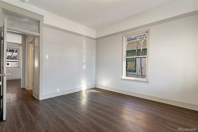 empty room with dark hardwood / wood-style floors