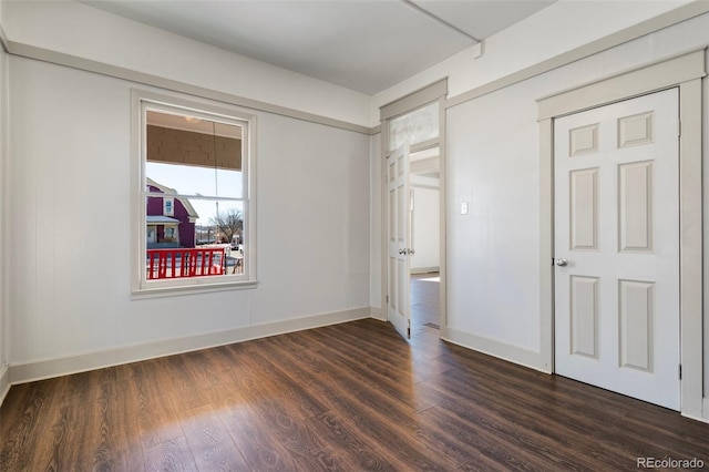 unfurnished bedroom featuring a closet and dark hardwood / wood-style floors