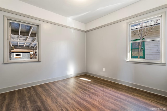 unfurnished room with dark wood-type flooring