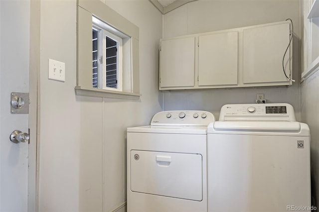 washroom featuring cabinets and independent washer and dryer