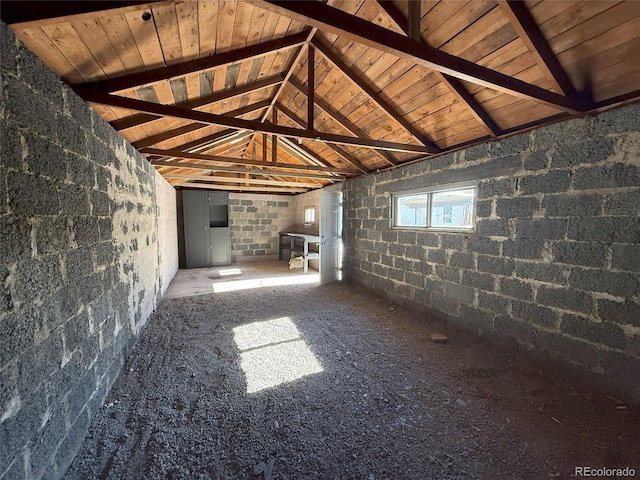 unfurnished living room featuring lofted ceiling with beams and wooden ceiling