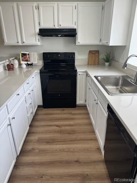 kitchen featuring dark hardwood / wood-style floors, sink, white cabinets, and black appliances