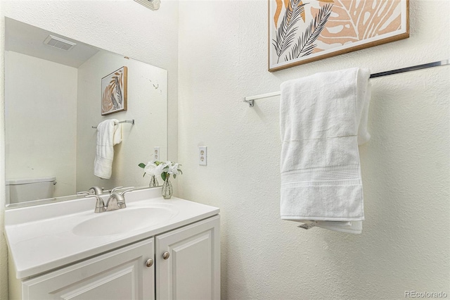 bathroom with toilet and vanity