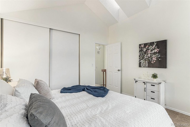 bedroom featuring a closet, vaulted ceiling, and carpet