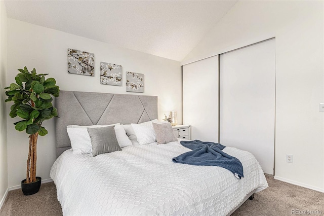 carpeted bedroom featuring a closet and vaulted ceiling