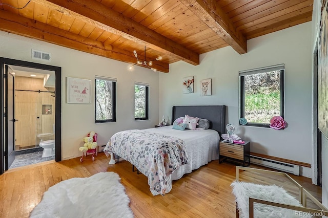 bedroom with a baseboard heating unit, visible vents, multiple windows, and light wood-type flooring