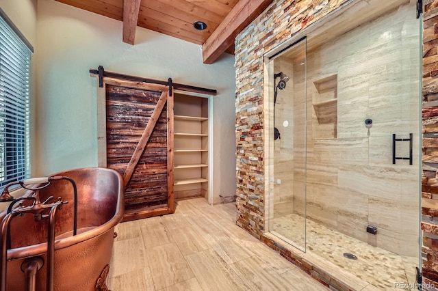 full bath featuring beamed ceiling, a shower stall, wood ceiling, and a freestanding tub