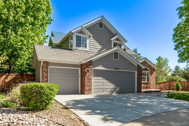 10345 Lions Heart, Lone Tree, CO 80124 - traditional home featuring brick siding, driveway, a shingled roof, an attached garage, and a garage