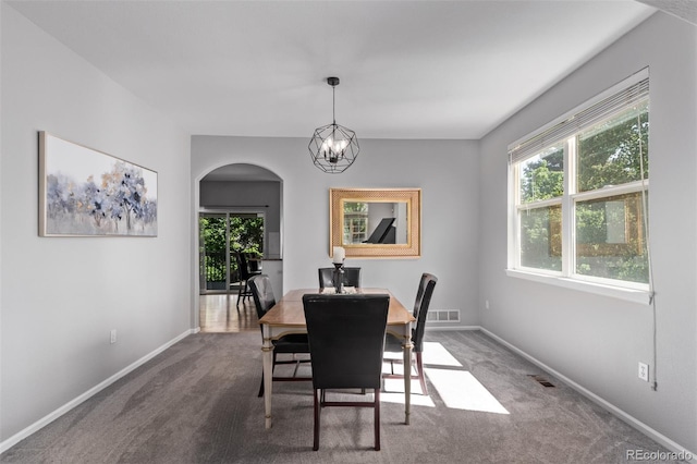 10345 Lions Heart, Lone Tree, CO 80124 - dining space featuring arched walkways, carpet, and a chandelier