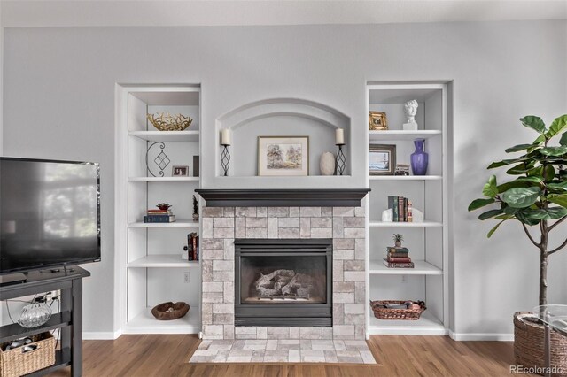 10345 Lions Heart, Lone Tree, CO 80124 - living room with wood finished floors, a fireplace with flush hearth, and built in features
