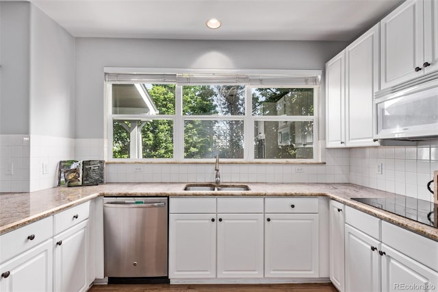 10345 Lions Heart, Lone Tree, CO 80124 - kitchen featuring stainless steel dishwasher, white microwave, backsplash, white cabinets, and recessed lighting