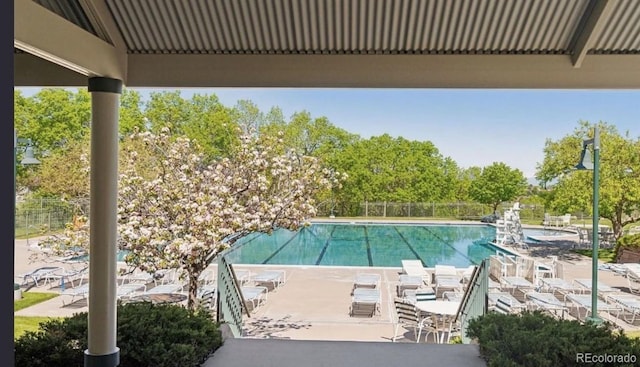 10345 Lions Heart, Lone Tree, CO 80124 - community pool with a patio and view of wooded area