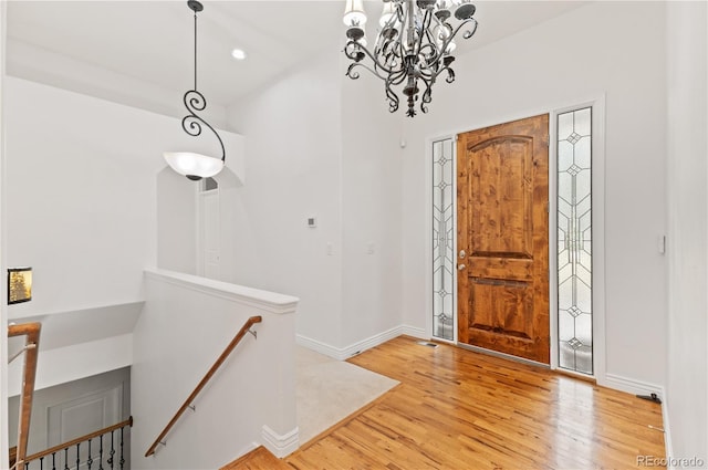 foyer entrance with a notable chandelier and wood-type flooring