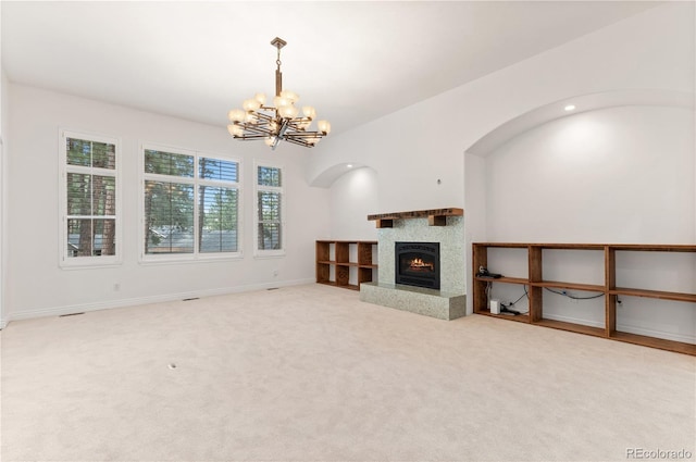 unfurnished living room with a chandelier and carpet flooring