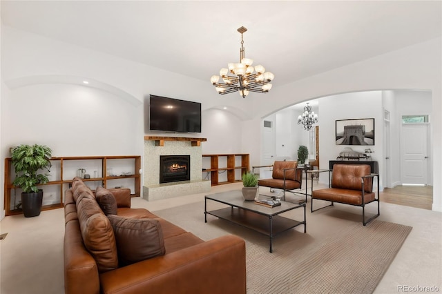 carpeted living room featuring a chandelier