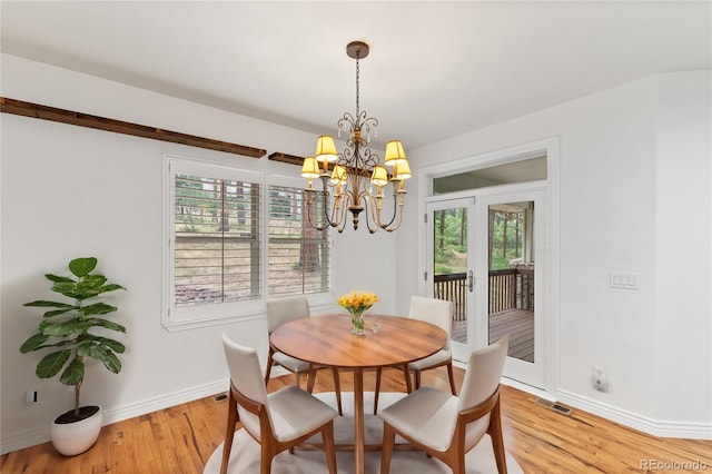 dining room featuring an inviting chandelier and light hardwood / wood-style floors