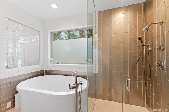 bathroom featuring tile walls, tile patterned floors, and independent shower and bath