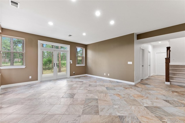 tiled spare room with french doors