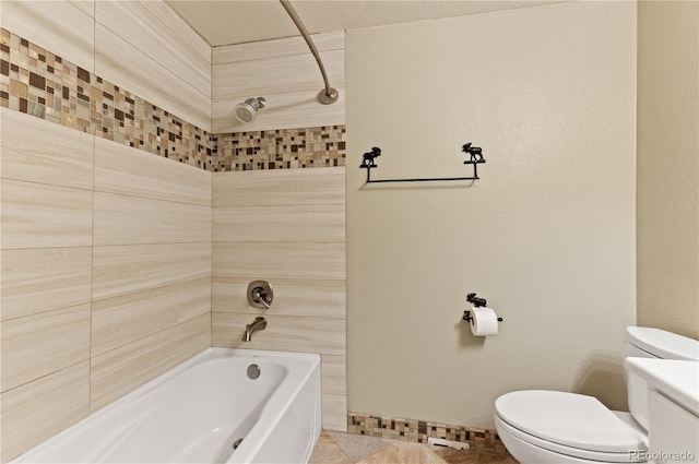 bathroom featuring toilet, tiled shower / bath combo, and tile patterned floors