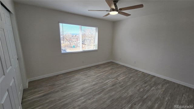 interior space with dark wood-style floors, baseboards, and ceiling fan