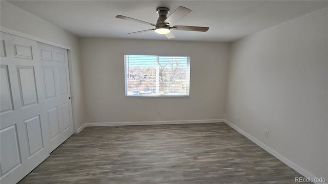 unfurnished bedroom with ceiling fan, a closet, baseboards, and dark wood finished floors