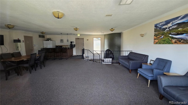 interior space featuring visible vents, a textured ceiling, and ornamental molding