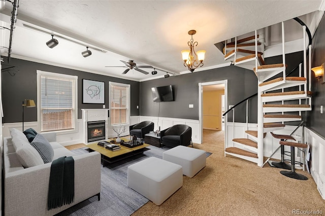 720 N Walnut St, Colorado Springs, CO 80905 - living area with stairway, light carpet, a glass covered fireplace, ceiling fan, and a wainscoted wall
