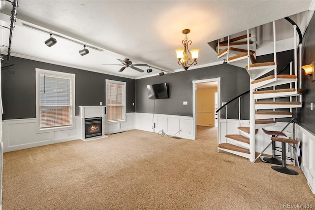 720 N Walnut St, Colorado Springs, CO 80905 - unfurnished living room with carpet floors, stairs, track lighting, a fireplace with flush hearth, and ceiling fan