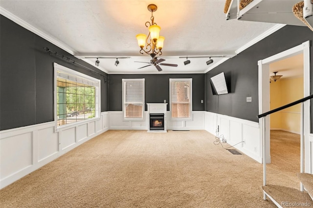 720 N Walnut St, Colorado Springs, CO 80905 - unfurnished living room with carpet, rail lighting, a chandelier, ceiling fan, and ornamental molding