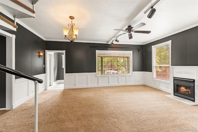 720 N Walnut St, Colorado Springs, CO 80905 - unfurnished living room featuring carpet flooring, a ceiling fan, a glass covered fireplace, ornamental molding, and a chandelier