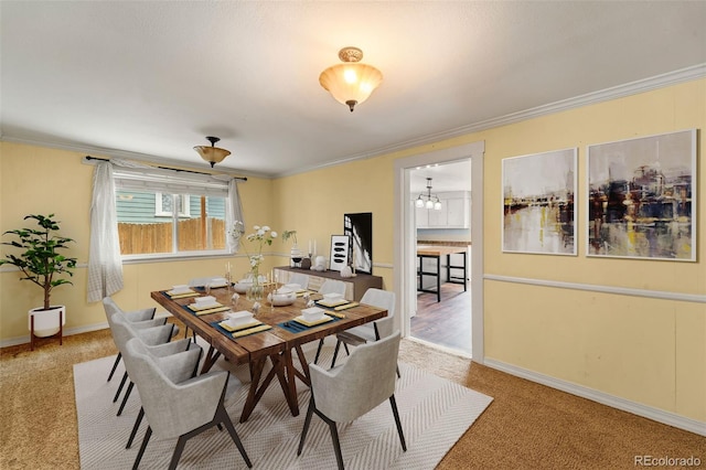 720 N Walnut St, Colorado Springs, CO 80905 - dining area with carpet flooring, crown molding, and a chandelier