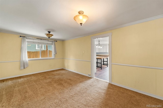 720 N Walnut St, Colorado Springs, CO 80905 - carpeted empty room featuring crown molding and a chandelier