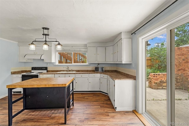720 N Walnut St, Colorado Springs, CO 80905 - kitchen featuring wooden counters, white range with electric stovetop, wood-type flooring, and white cabinetry