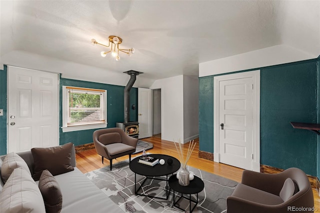 720 N Walnut St, Colorado Springs, CO 80905 - living room with a wood stove, light wood-style flooring, and lofted ceiling