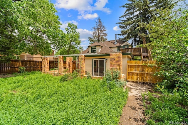 720 N Walnut St, Colorado Springs, CO 80905 - rear view of property with a fenced backyard and a wooden deck
