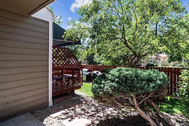 view of yard with a deck and fence