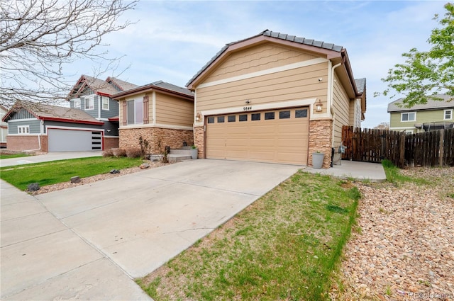 9844 Norfolk St, Commerce City, CO 80022 - view of front of property with driveway and stone siding