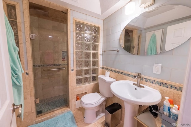 9844 Norfolk St, Commerce City, CO 80022 - bathroom featuring a stall shower, toilet, tasteful backsplash, tile patterned floors, and tile walls