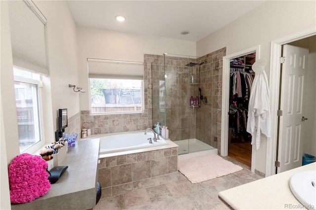 9844 Norfolk St, Commerce City, CO 80022 - bathroom featuring a shower stall, a garden tub, a spacious closet, and vanity