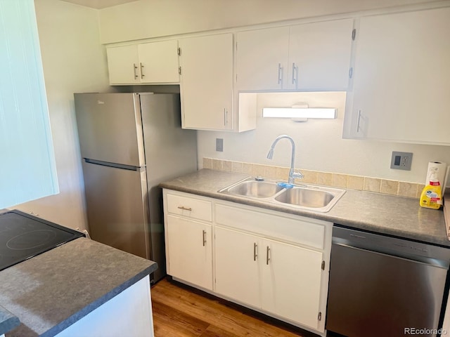 9255 E Lehigh Unit 213, Denver, CO 80237 - kitchen with appliances with stainless steel finishes, light wood finished floors, and white cabinets