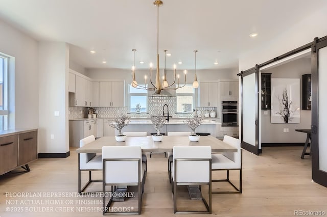 1768 Peak Loop, Broomfield, CO 80023 - kitchen featuring stainless steel double oven, white cabinets, tasteful backsplash, light wood finished floors, and recessed lighting
