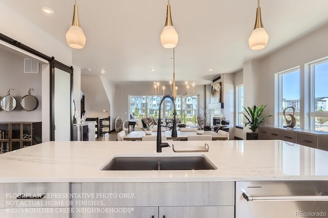 1768 Peak Loop, Broomfield, CO 80023 - kitchen featuring open floor plan, a barn door, healthy amount of natural light, and recessed lighting