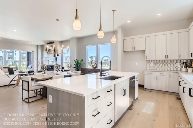 1768 Peak Loop, Broomfield, CO 80023 - kitchen with open floor plan, light wood finished floors, a chandelier, healthy amount of natural light, and recessed lighting