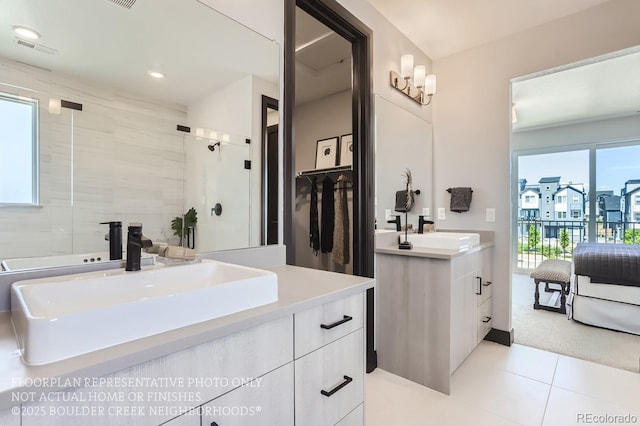 1768 Peak Loop, Broomfield, CO 80023 - ensuite bathroom with vanity, tile patterned floors, a shower with door, and recessed lighting