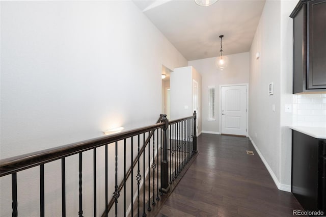 8230 Misty Moon Dr, Colorado Springs, CO 80924 - corridor with dark wood-style flooring, an upstairs landing, and baseboards