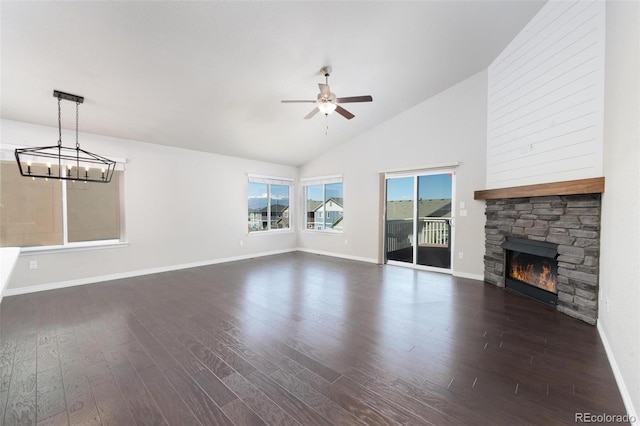 8230 Misty Moon Dr, Colorado Springs, CO 80924 - unfurnished living room with a ceiling fan, dark wood finished floors, a fireplace, and high vaulted ceiling