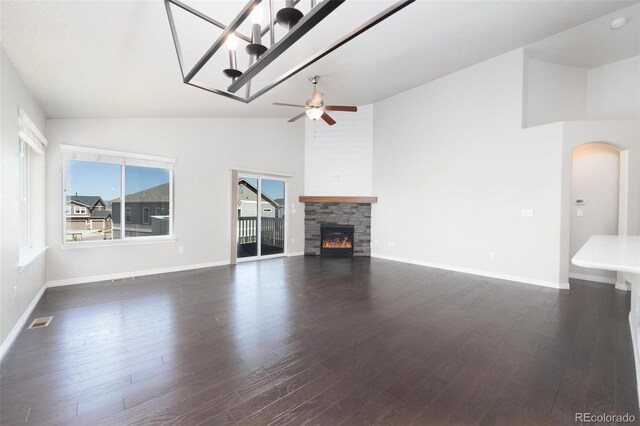 8230 Misty Moon Dr, Colorado Springs, CO 80924 - unfurnished living room featuring lofted ceiling, a ceiling fan, a fireplace, dark wood-type flooring, and baseboards